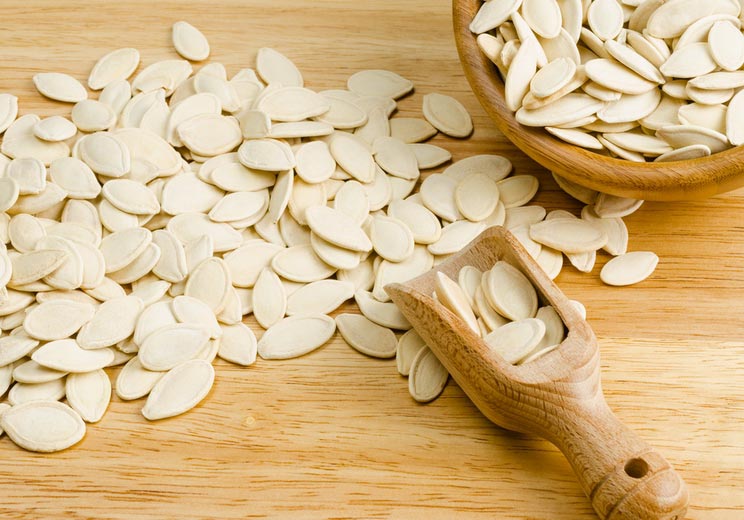 Dried-pumpkin-seeds-on-wooden-background.jpg