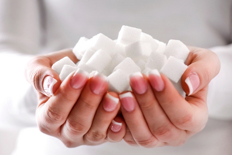White-sugar-cubes-in-woman-beautiful-hands.jpg