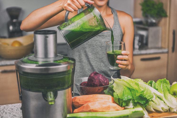 Woman-juicing-making-green-juice.jpg