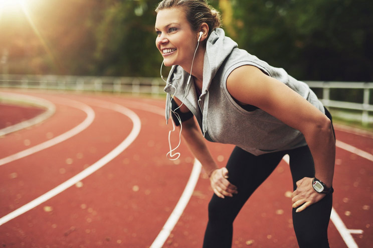 Sportswoman-on-track-field-listening-to-music.jpg