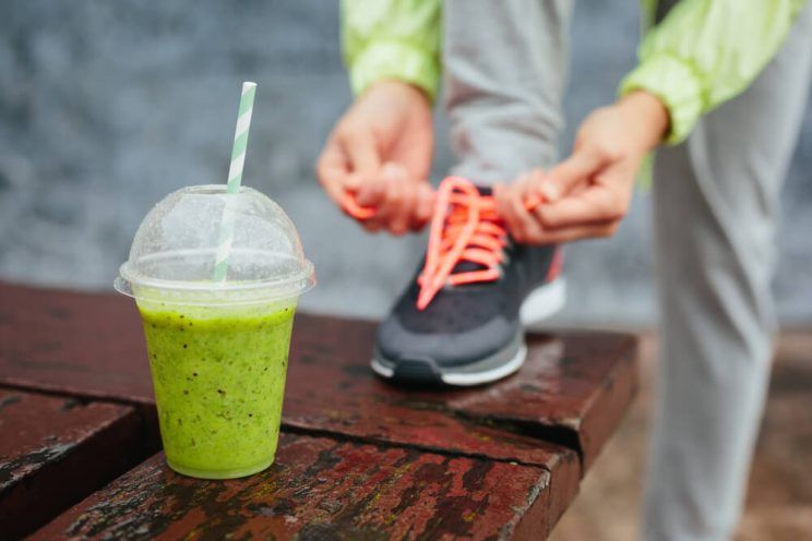 Green-detox-smoothie-cup-and-woman-lacing-running-shoes-e1461303381381.jpg