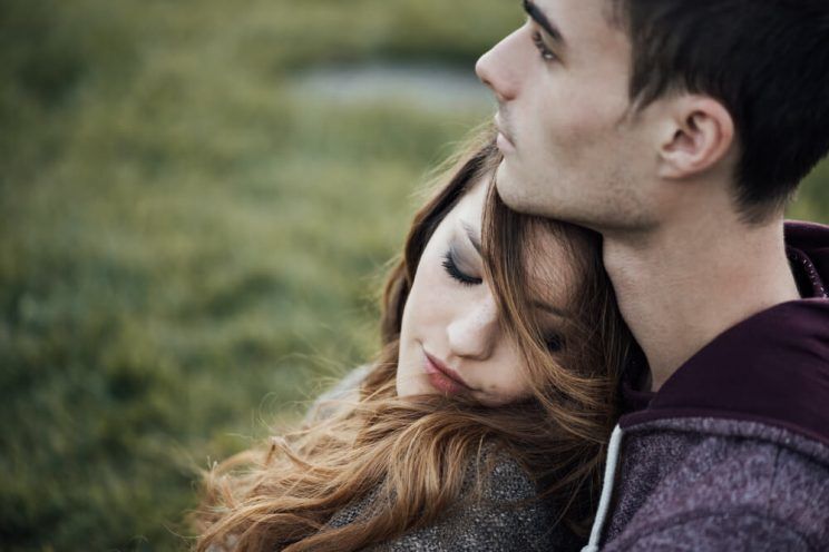 Young-loving-couple-outdoors-sitting-on-grass-e1461303459798.jpg