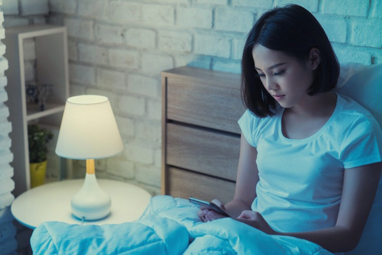 Women-are-using-the-smart-phone-on-the-bed-before-she-sleeping-at-night.jpg